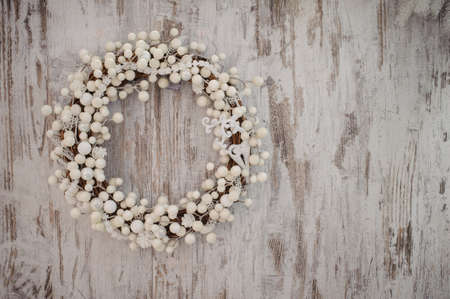 white christmas decorative wreath over the wooden backgroundの写真素材