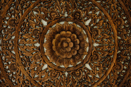 Pattern of flower carved on wood background Thailandの写真素材