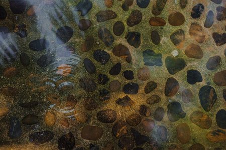 abstract background with rounded pebble stones under water textureの写真素材