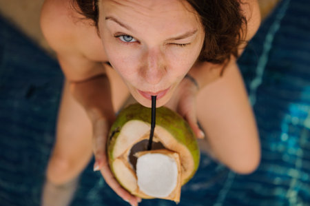 woman drinking coconut . Happy carefree freedom girl in summer day. top view