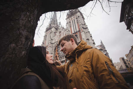 Happy young couple smiling outdoors looking at each other with love. coldの写真素材