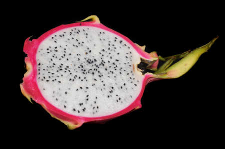 Fresh dragon fruit cut in half isolated on a black background closeupの写真素材