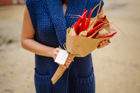 The original unusual edible bouquet of vegetables and fruits on  wood with card in woman handsの写真素材