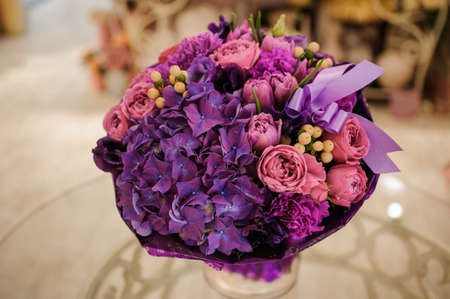 purple and pink flower bouquet composition  on tableの写真素材