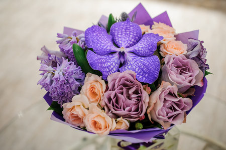 purple and pink flower bouquet composition  on table