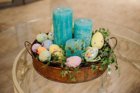 Easter blue candle eggs composition on tableの写真素材
