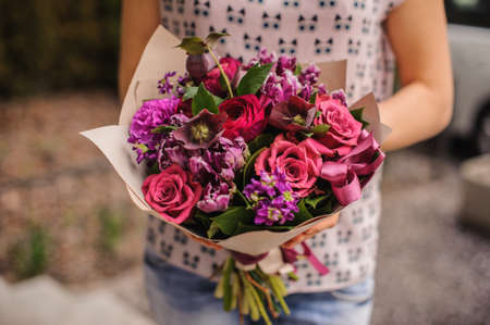 purple and pink flower bouquet composition  in handsの写真素材