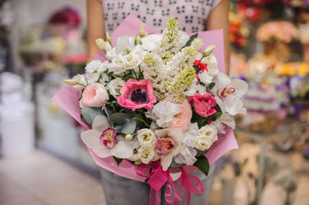 Rich bunch of white and pink flowers in woman handsの写真素材