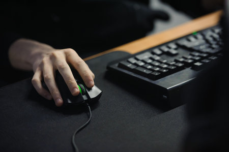 Male hand holding computer mouse no face