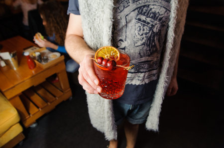 Closeup of a man holding cocktail no face