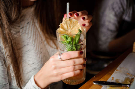 Woman holding a cocktail glass no faceの写真素材