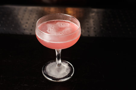 Cosmopolitan pink cocktail on top of bar