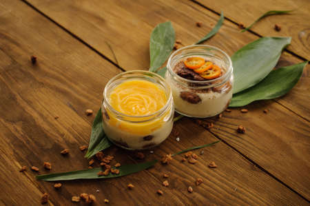 tiramisu and lemon custard desserts on wooden background close upの写真素材