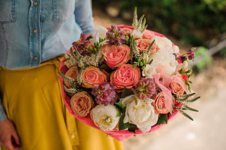 girl holding Bouquet of the different mixed orange and white flowers no faceの写真素材