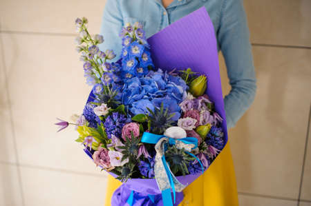 girl holding purple and pink flower bouquet no faceの写真素材