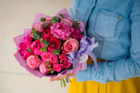girl holding bouquet of a mixed pink and purple flowers no faceの写真素材