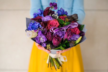 girl holding purple and pink flower bouquet no faceの写真素材