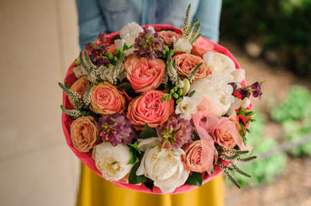 girl holding Bouquet of the different mixed orange and white flowers no faceの写真素材