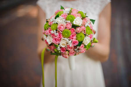 Bride in white dress with a wedding bouquet. no faceの写真素材