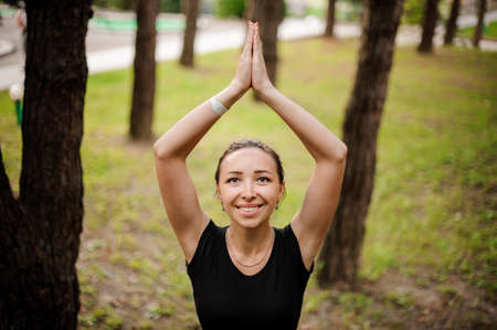 Practicing of yoga outdoors in the forestの写真素材