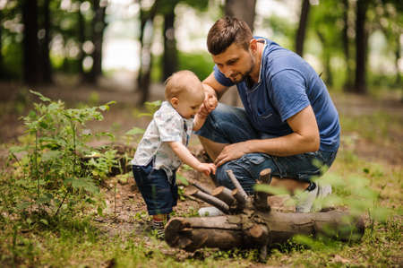 father and sons relationship, playing with dandelions in the Parkの写真素材