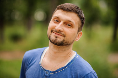 A portrait of a young white handsome man posing outdoors.の写真素材