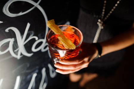 Negroni in the hand. Close up