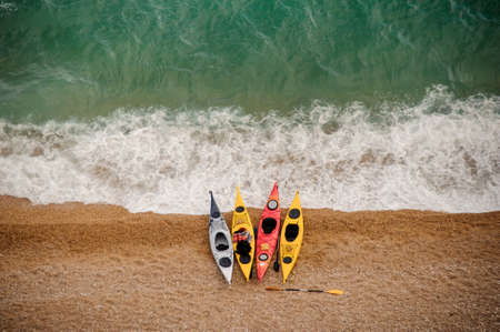 Colorful kayaks on sandy beach. Water sports.の写真素材