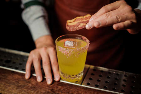 Delicious cocktail based on vodka with bacon and salt close upの写真素材