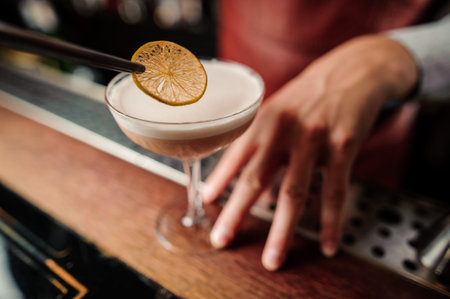 Sicilian sour cocktail in bartenders hands close up