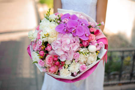 Beautiful mixed bouquet and bride close up no faceの写真素材