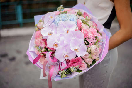 Hands with a beautiful and gentle pink composition of many flowers no face close upの写真素材