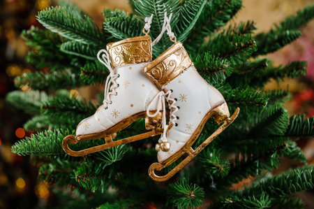 Christmas toys in the form of vintage white skates hang on a spruce branch