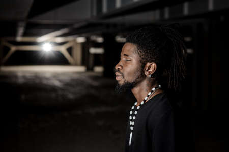 Close up profile portrait of dark skinned manの写真素材