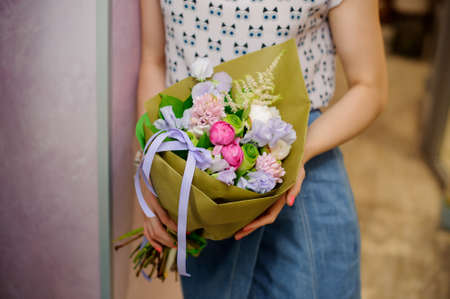 Refined and stylish colorful bouquet of beautiful flowers in woman hands. No face, close upの写真素材