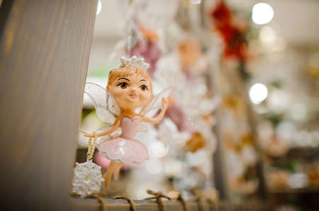 Christmas tree toy in the form of lovely fairy with wings, dressed in cute pink dressの写真素材