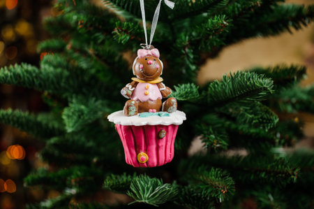 Christmas tree decoration toy in the form of sweet pink cupcake with cute toy on the topの写真素材