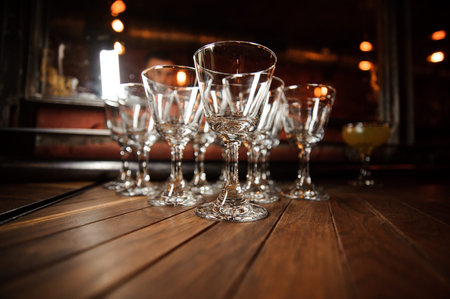 Close up photo of the set of washed and clean empty cocktail glasses on the floor. Cocktail glass...