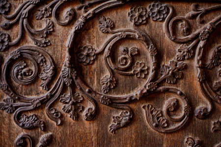 Beautiful texture of wooden wrought and decorated door in european styleの写真素材