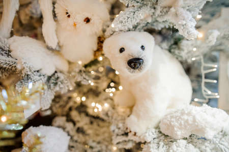 Soft Christmas tree decoration toy in the form of a cute little white polar bearの写真素材