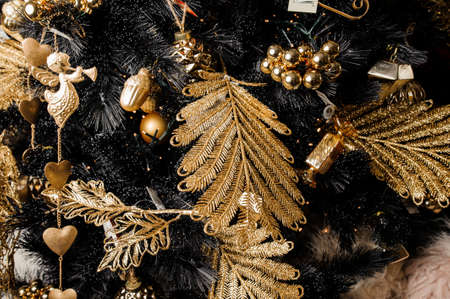 Stylish Christmas decorative garland in golden tones and in a form of leafs, angels and conesの写真素材