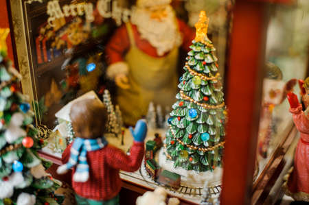 Christmas toy decorative composition consisting of a boy looking through the window of a toy shopの写真素材