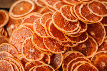 Close up view of thin, fresh and tasty slices of juicy orange fruits arranged chaotically