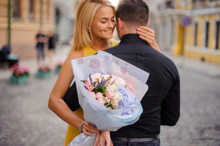 pretty blonde girl with a bouquet of flowers including roses, astilba, carnations and hydrange hugs...