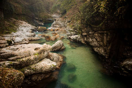 Clear green mountain river flowing between two high rocks with plants in Georgia. Martvili canyon. Okatse canyonの写真素材