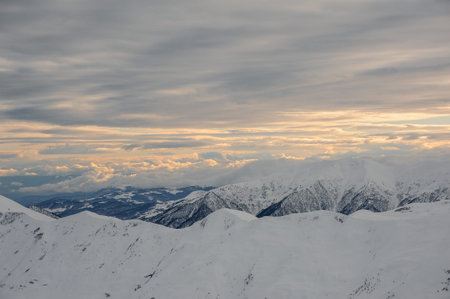 Amazing top view of cloudy sky and high mountain peaks