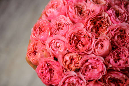 Top view photo of a gorgeous bouquet of flowers consisting of bright pink peony rose on the floorの写真素材