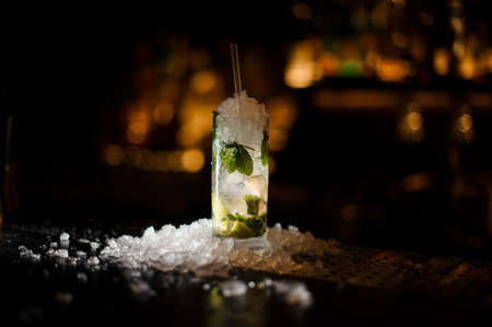 Fresh delicious cocktail Caipirinha with lime, mint and ice standing on the steel bar counterの写真素材