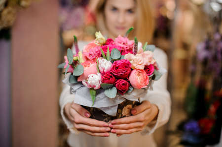 Girl holding a beautiful bouquet of different colour rosesの写真素材