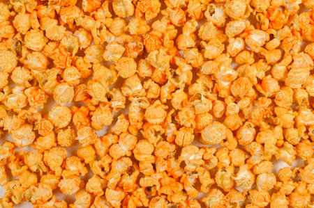 large airy grains of yellow delicious roasted spicy popcorn cover an even layer of surfaceの写真素材